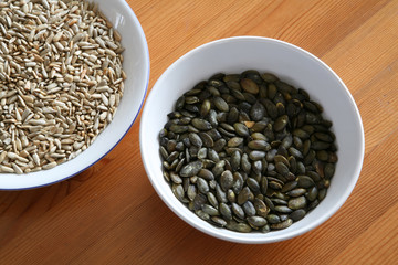 sunflower and pumpkin seeds in white porcelain bowl