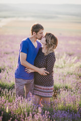 Happy couple posing in a lavender field. Summer mood