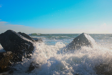 Violent waves crashing against large rocks in the ocean. Shot in Newport, Rhode Island