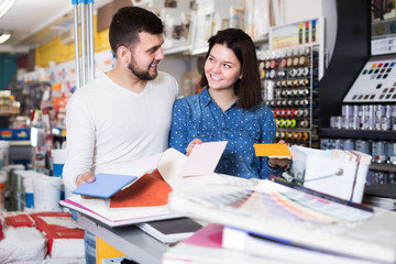 Couple in paint supplies store