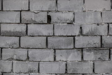 The old brick and stone wall with plaster