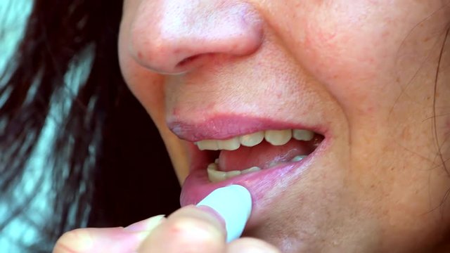 graded shot of closeup of  lipstick on mature lips of Caucasian woman with Arabic and Middle Eastern somatic traits with very soft skin
