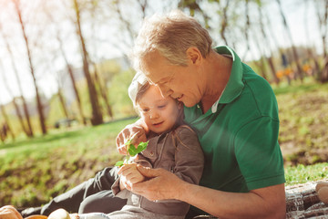 Man with granddaughter exploring plant