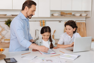 Fototapeta premium Young father explaining math to his children