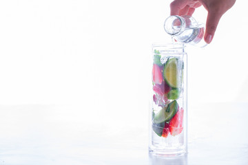 Drink with ice, berries, citrus and mint. Detox. Strawberry., lime. Mojito in a glass bottle.Food or Healthy diet concept.Super Food.Vegetarian.Copy space for Text.selective focus.