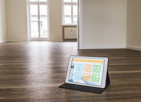 Tablet with smart home apps on wooden floor