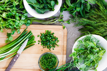 Background with Herbs, Chopped Scallion, Dill, Mint Leaves, Parsley on the Dark Background