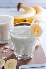 Banana chilled smoothies with banana, milk, almonds and honey, selective focus