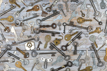 Old keys on wooden background