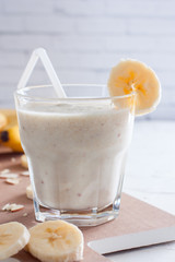 Banana chilled smoothies with banana, milk, almonds and honey, selective focus