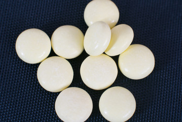 Pharmacy theme, white medicine tablets isolated on black background