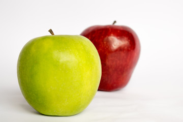 Two apples together a red and a green (isolated). Different concept.