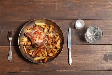 dinner with pan fried meat and potatoes on a table