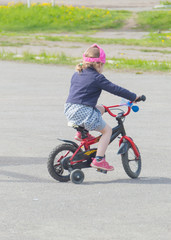 baby girl riding her bike on the Playground.