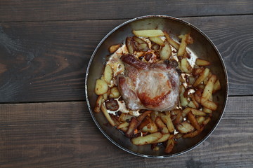 dinner with pan fried meat and potatoes on a table