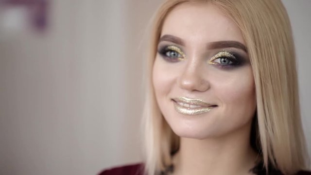 Makeup artist makes a girl beautiful makeup before an important event