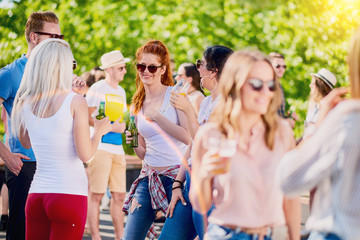 Group of friends chatting, smiling and having a good time at the party