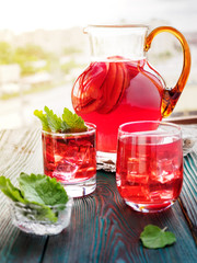 Berry compote decanter glasses with apple slices on wooden rustic background solar.