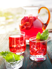 Berry compote decanter glasses with apple slices on wooden rustic background solar.
