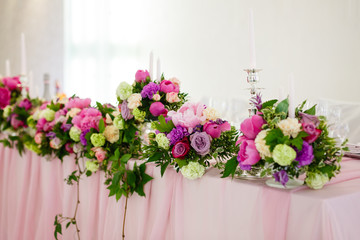 Pink roses bouquet over wooden table. Top view with copy space