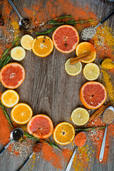Round frame with sweet citrus fruits on a dark background. the view from the top.