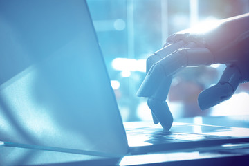  Robot finger point to laptop button with blue tone image. Chat bot , artificial intelligence ,...