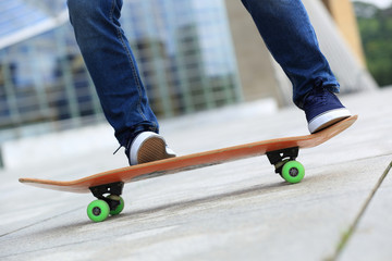 Skateboarder legs skateboarding at city