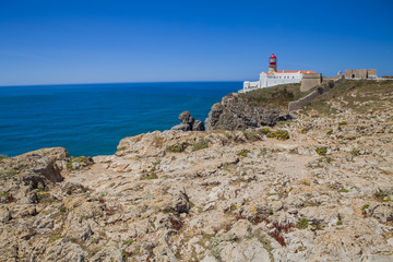 Fototapeta na wymiar Lighthouse at Cabo de Sao Vicente, Algarve, Portugal. The lighthouse is situated on the tip of the Cape of St. Vincent, the extreme southwesternmost point in Europe 