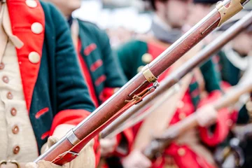 Building musketeers with guns. Focus on the gun © SharlottaU