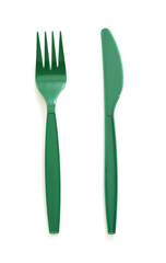 Green plastic knife and fork isolated on white