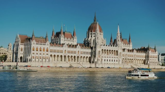 A tourist boat sails on the Danube against the background of the Hungarian Parliament building in Budapest