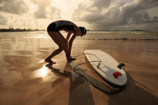 Young woman surfer with surfboard ready to surf