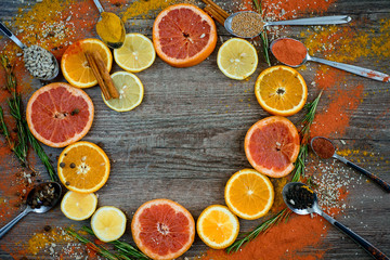 Round frame with sweet citrus fruits on a dark background. the view from the top.