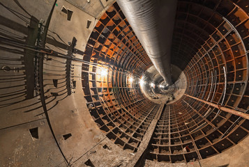 Empty underground tunnel under construction for the subway. Large temporary ventilation pipe under the ceiling.