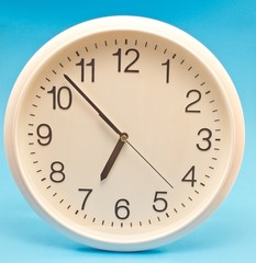 Fototapeta na wymiar Wall clock isolated on blue background