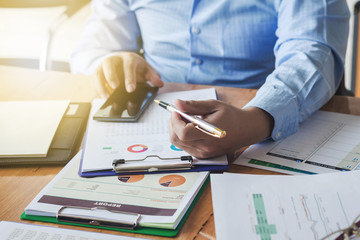 Hand in hand Business graph information on the desk is a morning concept