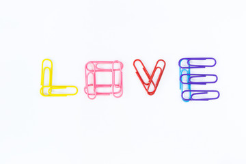 LOVE word by paper clips on white background