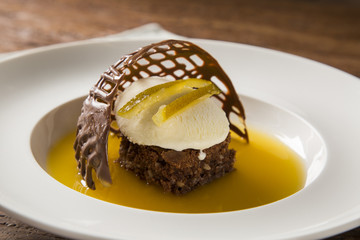 Chocolate cookie with ice cream and orange sauce