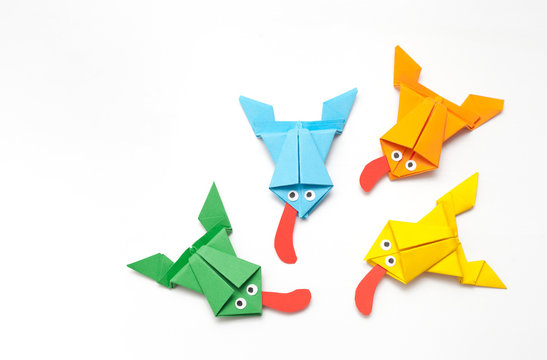 Frogs folded from colored paper in origami technique