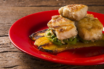 Tucunare fish in butter with green peppers and banana - Traditional Amazonian dish