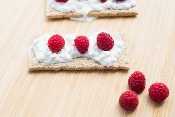 Crunchy rye-wheat bread with white cottage cheese and raspberries