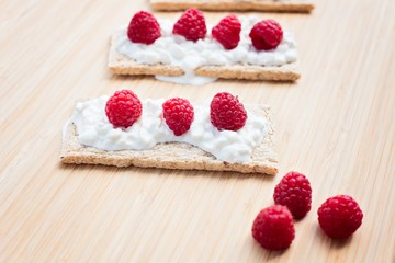 Crunchy rye-wheat bread with white cottage cheese and raspberries