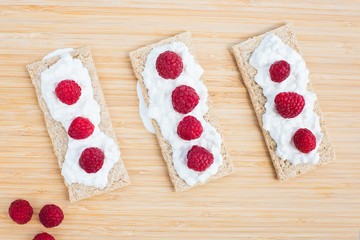 Crunchy rye-wheat bread with white cottage cheese and raspberries