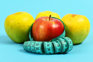Set of red and yellow apples wrapped with measuring tape