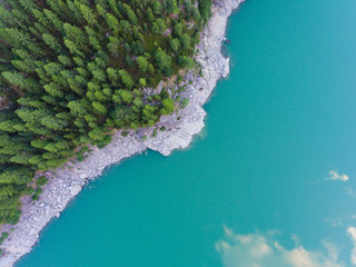 Trees and lake from above - Crystallin water and green forest - Aerial view with drone