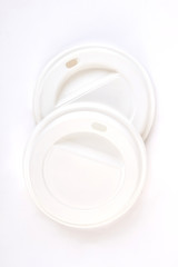 White disposable lids, top view. Caps for coffee container.