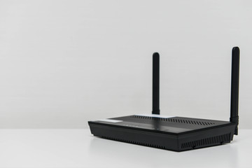 Black wireless router on the white table