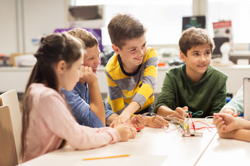 happy children building robots at robotics school
