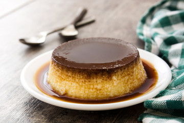 Creme caramel. Egg pudding on wooden background
