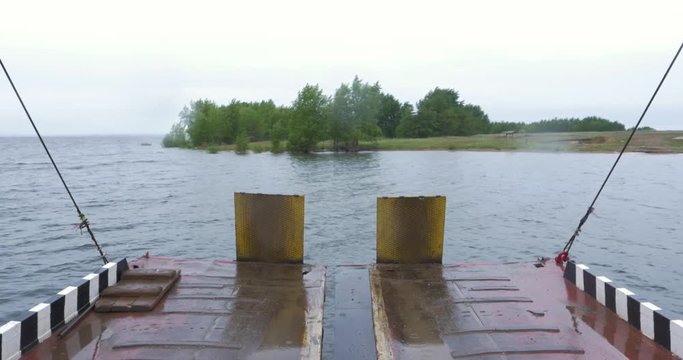 Ferry boat beach and a river. Ferry approaching with open ramp to El Rompido Marina. This little boat only for passengers.